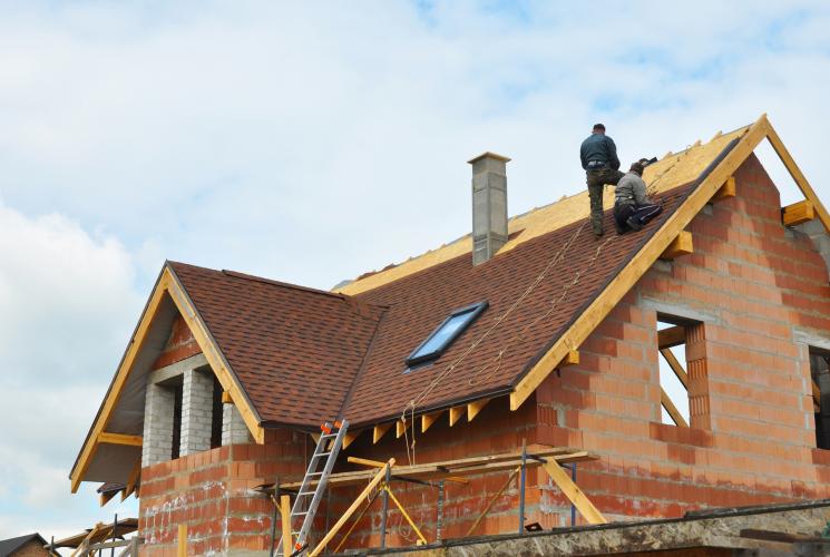 Roof under construction with person standing on it